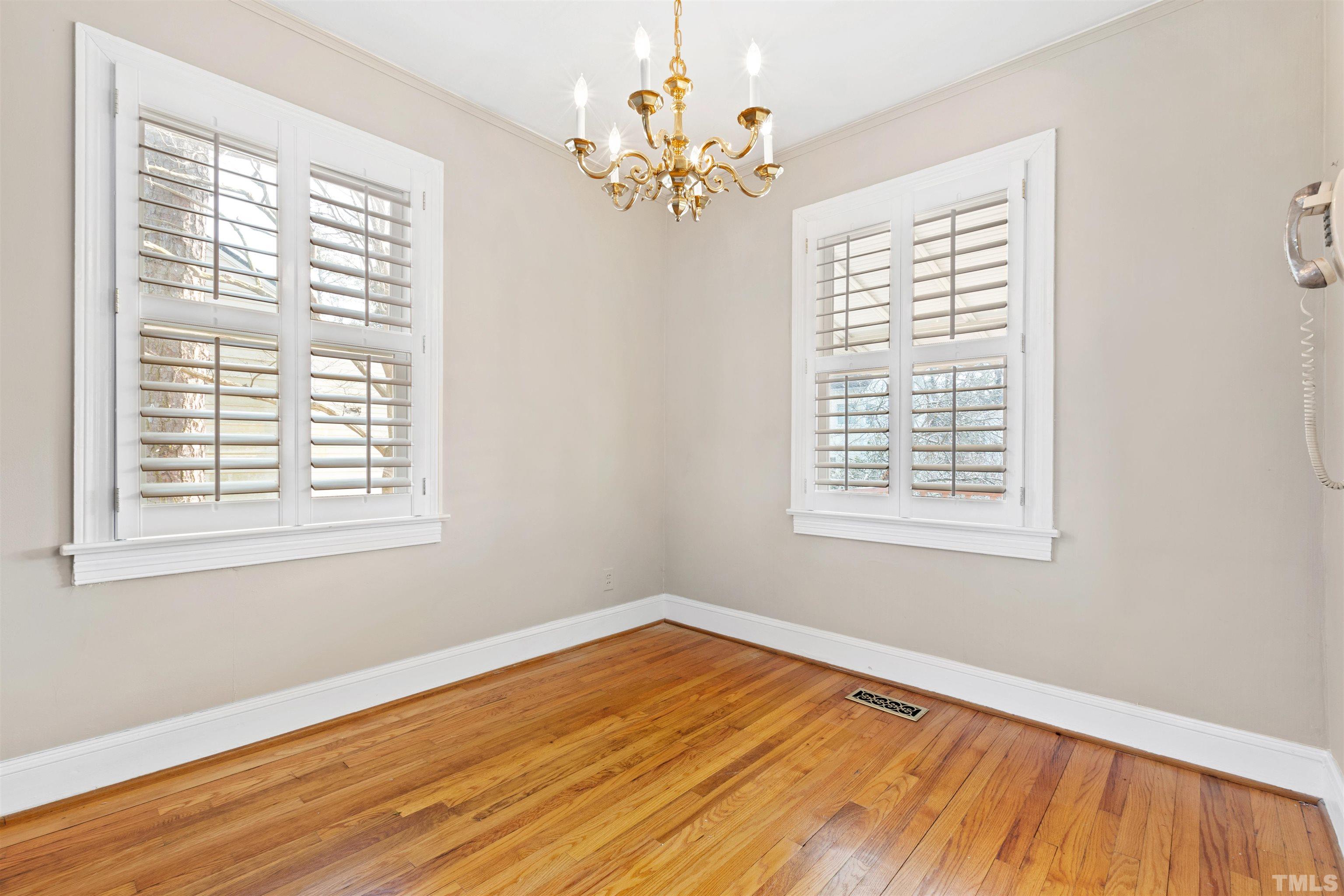 2713 Gordon Street Raleigh, NC 27608 - Photo 15 of 35 a view of an empty room with wooden floor and a window