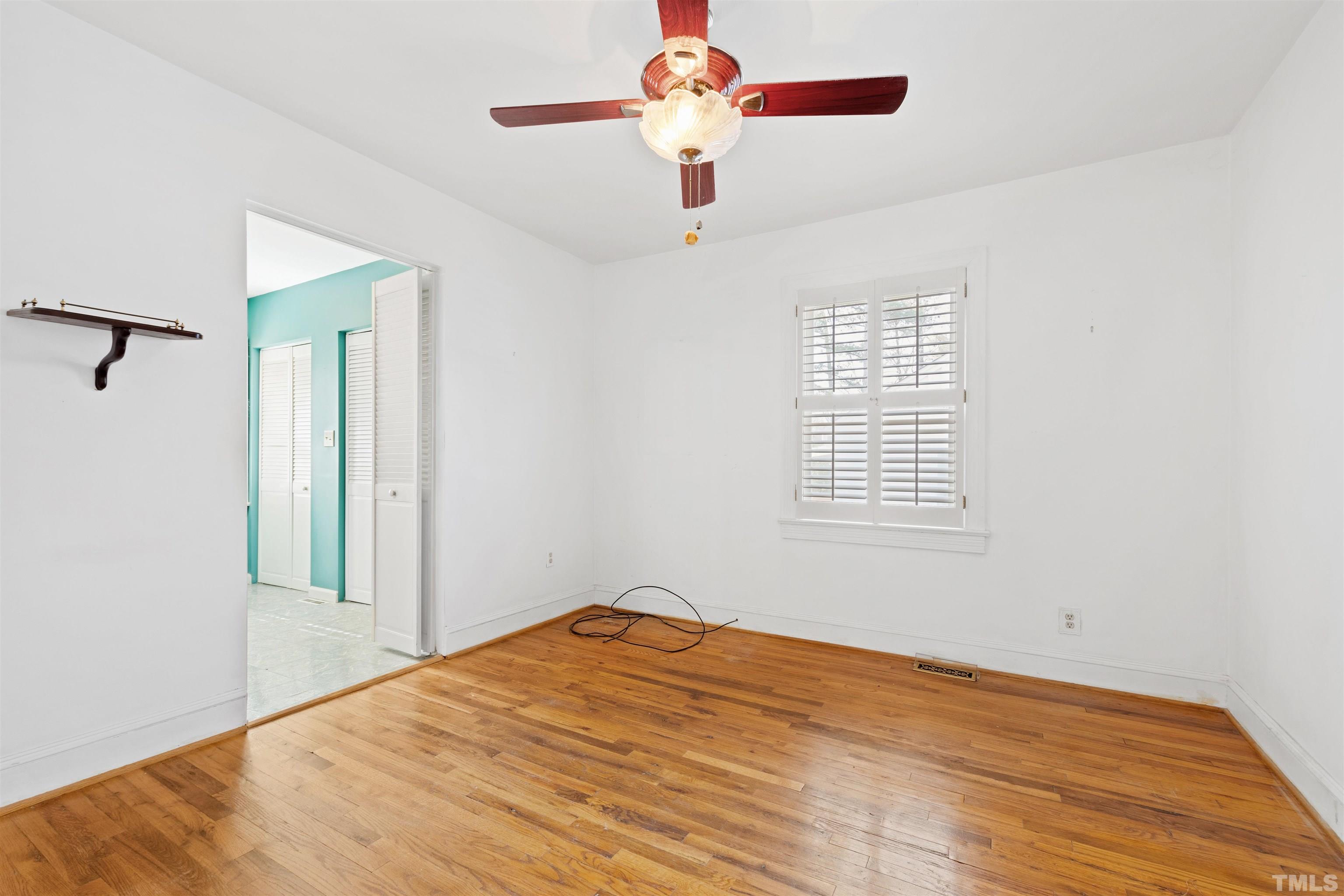 2713 Gordon Street Raleigh, NC 27608 - Photo 18 of 35 a view of a room with wooden floor and chandelier fan