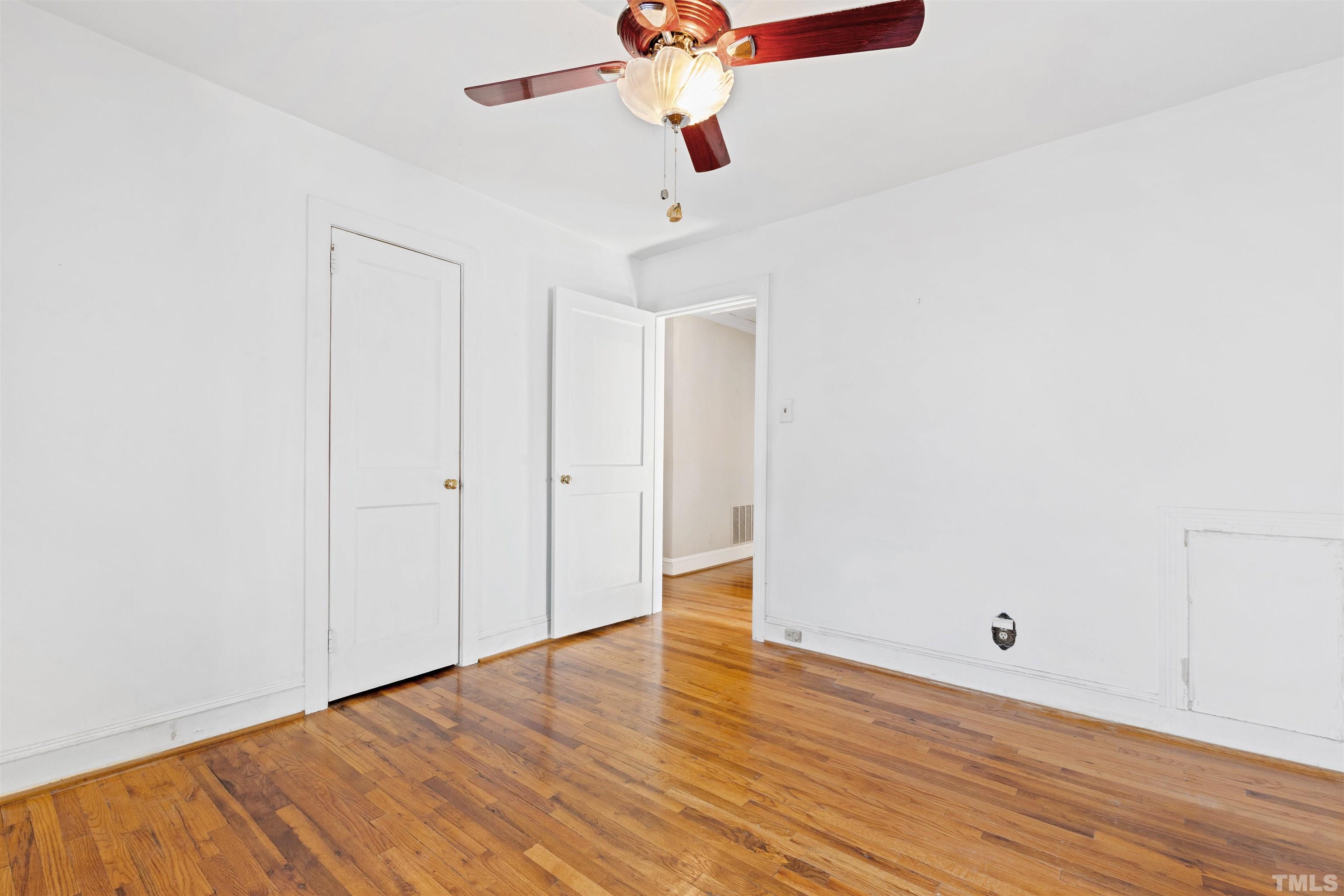 2713 Gordon Street Raleigh, NC 27608 - Photo 20 of 35 a view of a room with wooden floor and ceiling fan