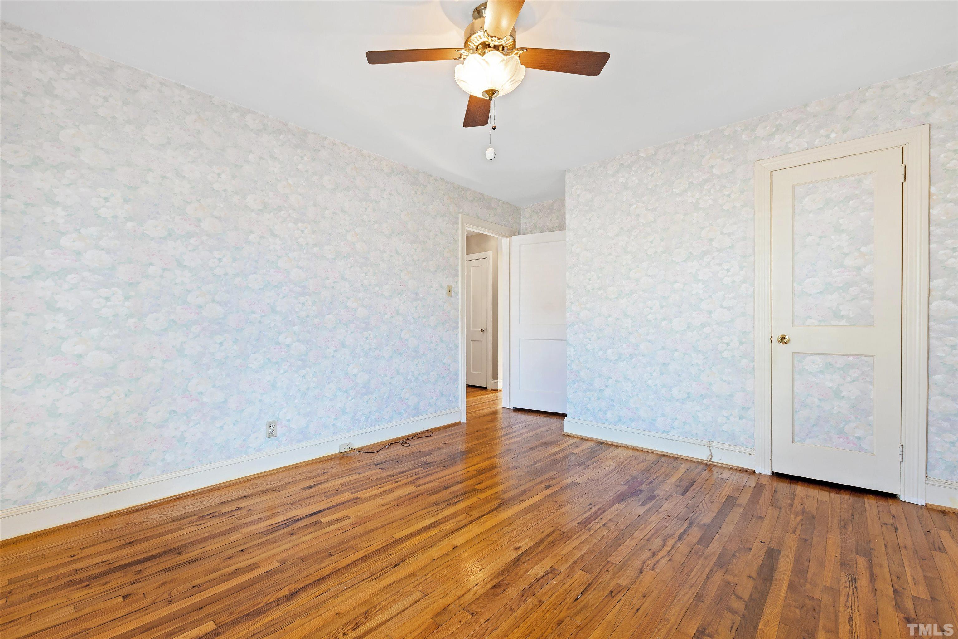 2713 Gordon Street Raleigh, NC 27608 - Photo 25 of 35 an empty room with wooden floor ceiling fan and windows