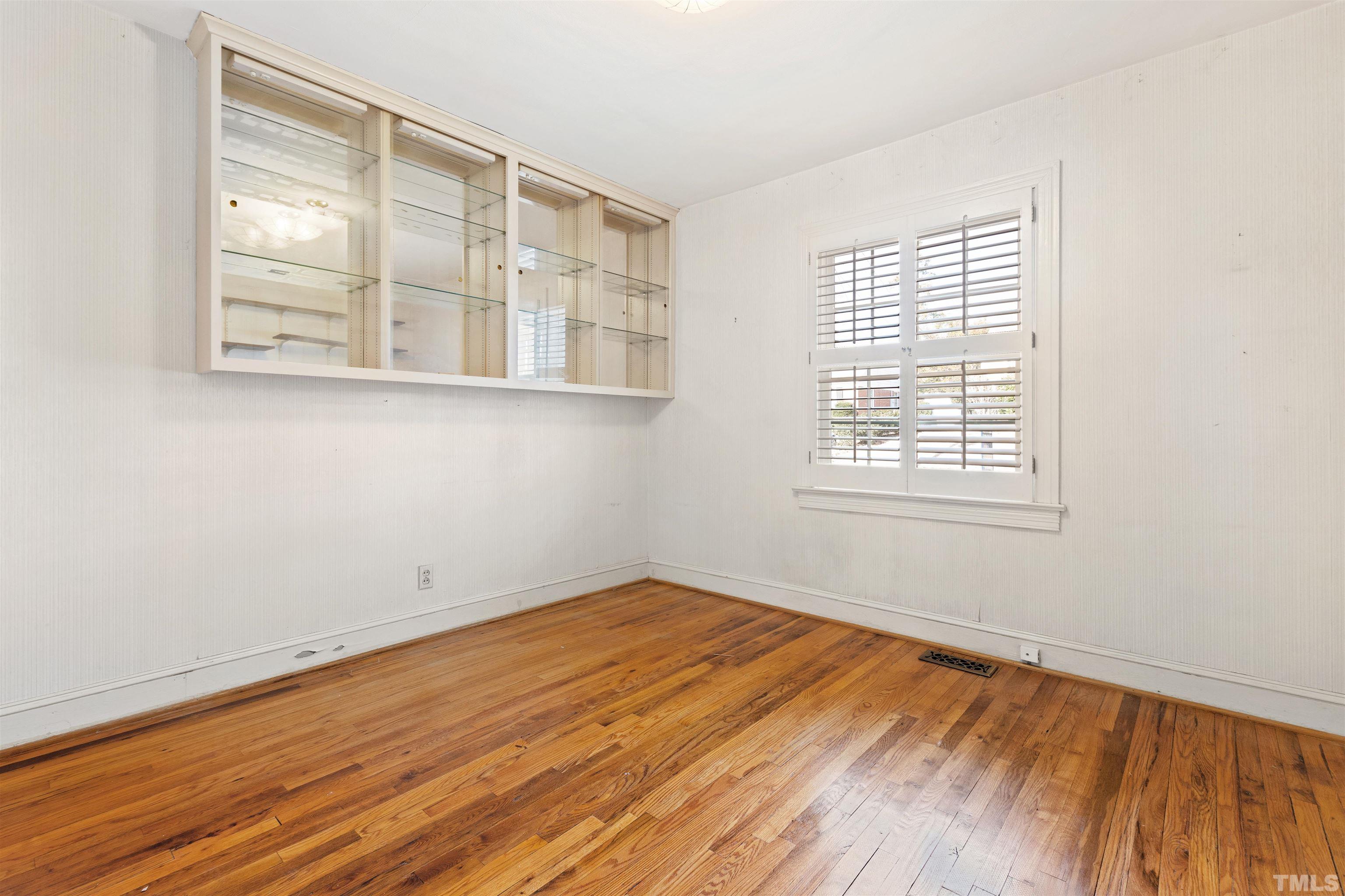 2713 Gordon Street Raleigh, NC 27608 - Photo 30 of 35 an empty room with wooden floor and windows