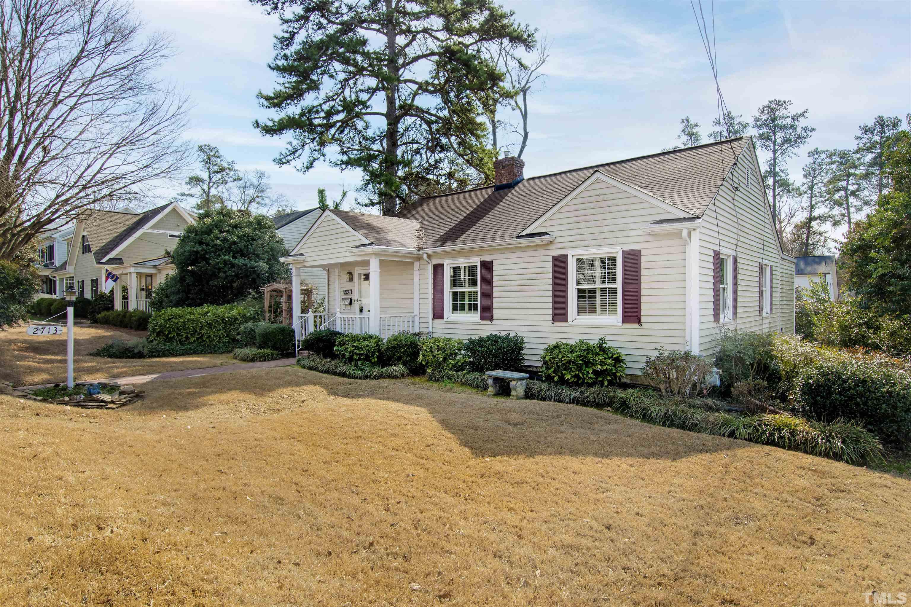 2713 Gordon Street Raleigh, NC 27608 - Photo 3 of 35 a white house with a large tree in front of it