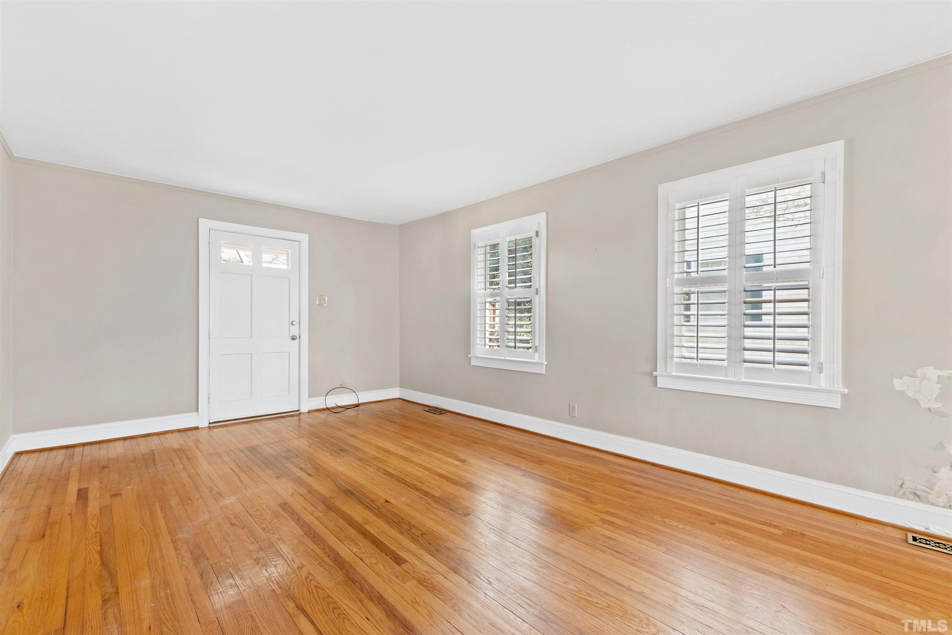 2713 Gordon Street Raleigh, NC 27608 - Photo 7 of 35 a view of an empty room with wooden floor and a window