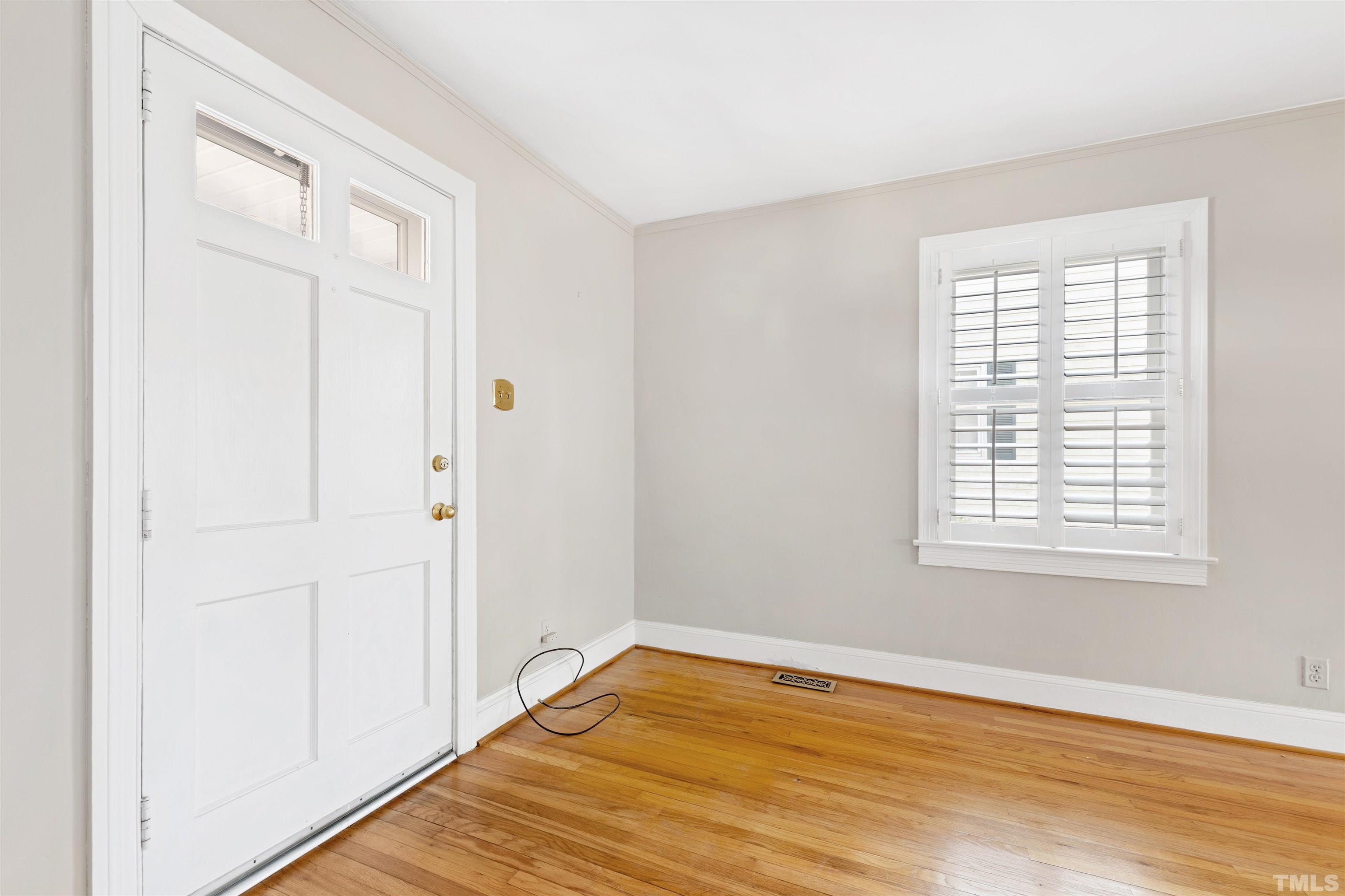 2713 Gordon Street Raleigh, NC 27608 - Photo 8 of 35 a view of an empty room with wooden floor and a window