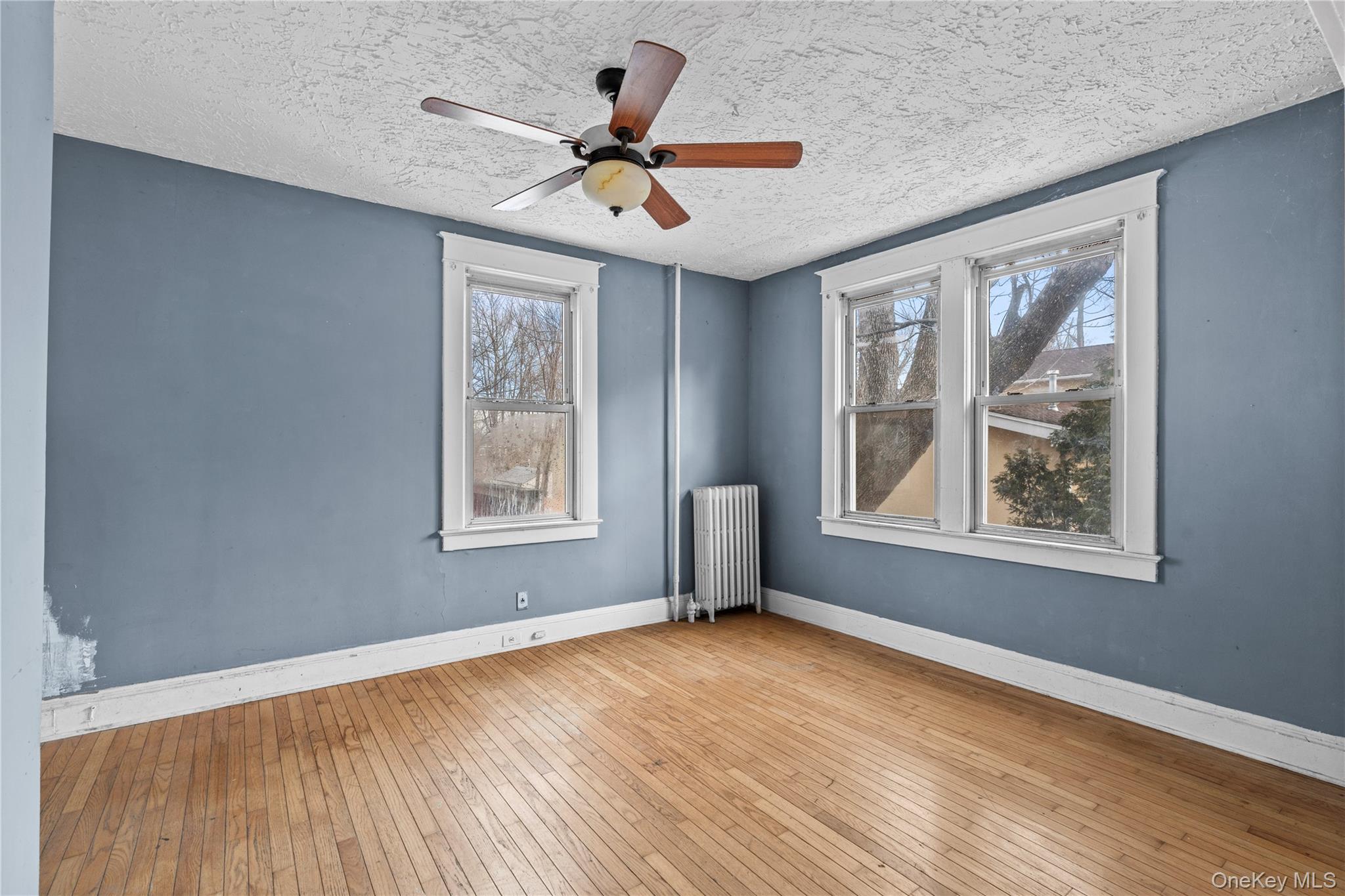 21 Stephens Lane Tappan, NY 10983 - Photo 11 of 30 a view of livingroom with window ceiling fan and hardwood floor