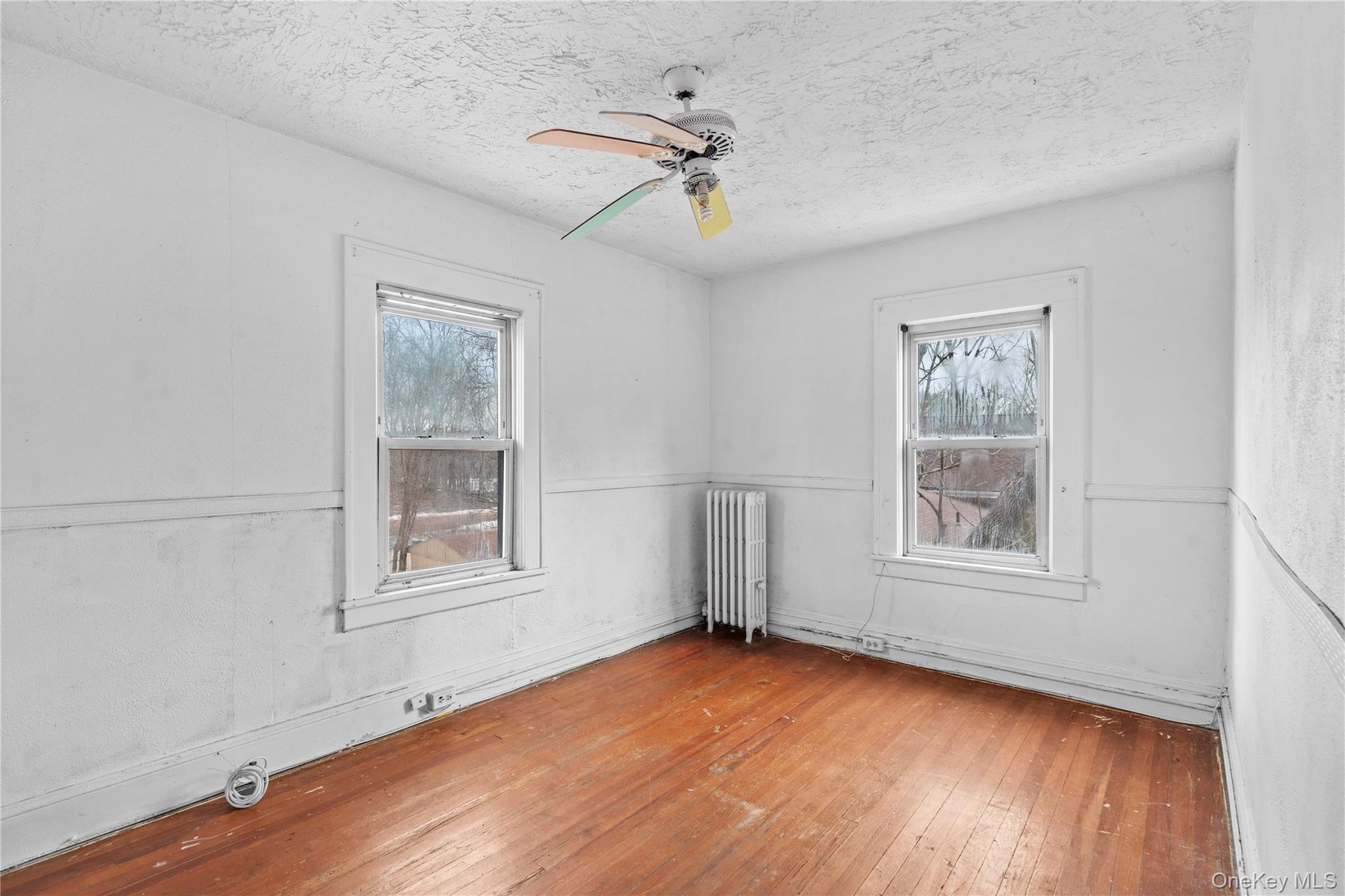 21 Stephens Lane Tappan, NY 10983 - Photo 20 of 30 an empty room with wooden floor chandelier and windows