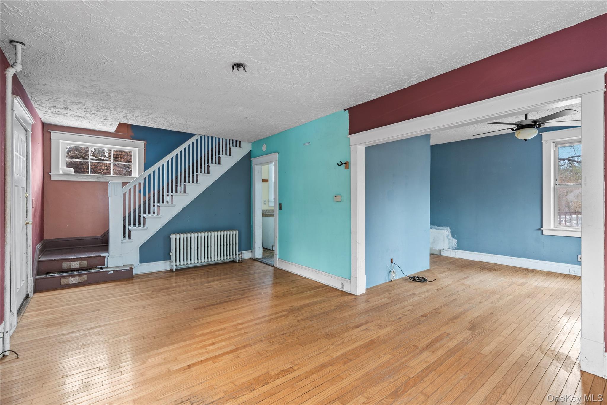 21 Stephens Lane Tappan, NY 10983 - Photo 7 of 30 a view of an empty room with wooden floor and stairs
