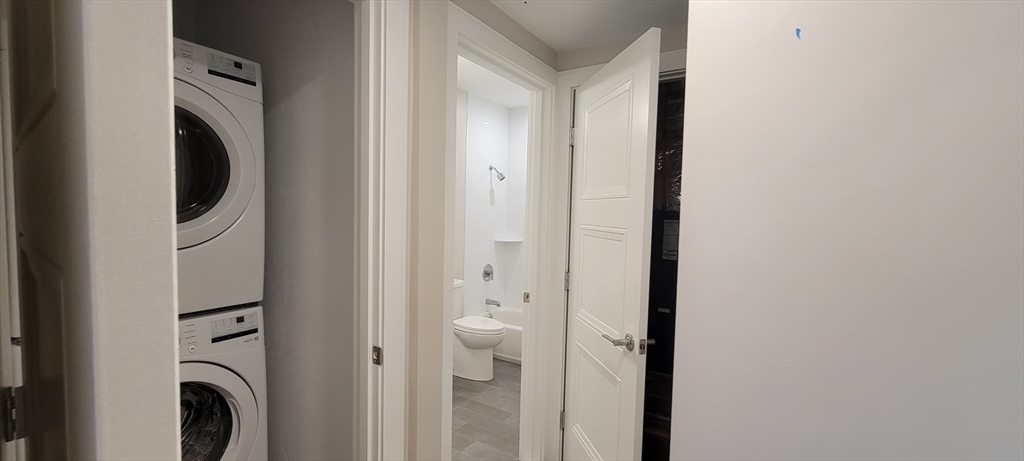 425 Lagrange Street, Unit 206 Boston, MA 02132 - Photo 11 of 15 a view of a hallway with washer and dryer