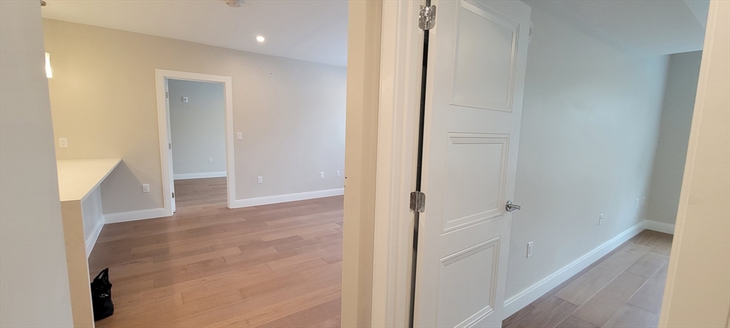425 Lagrange Street, Unit 206 Boston, MA 02132 - Photo 15 of 15 a view of a hallway with wooden floor