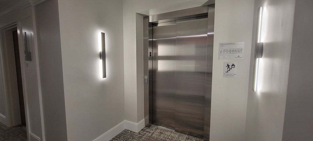 425 Lagrange Street, Unit 206 Boston, MA 02132 - Photo 3 of 15 a bathroom with a glass shower door