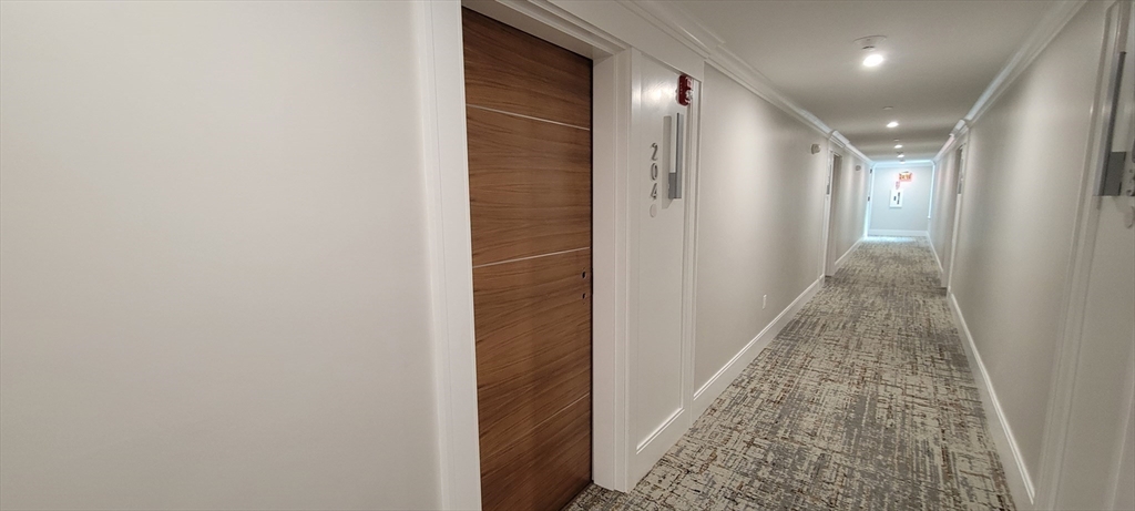425 Lagrange Street, Unit 206 Boston, MA 02132 - Photo 5 of 15 a view of hallway with shower