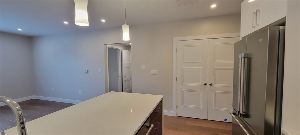 425 Lagrange Street, Unit 206 Boston, MA 02132 - Photo 9 of 15 a bedroom with a bed and a table