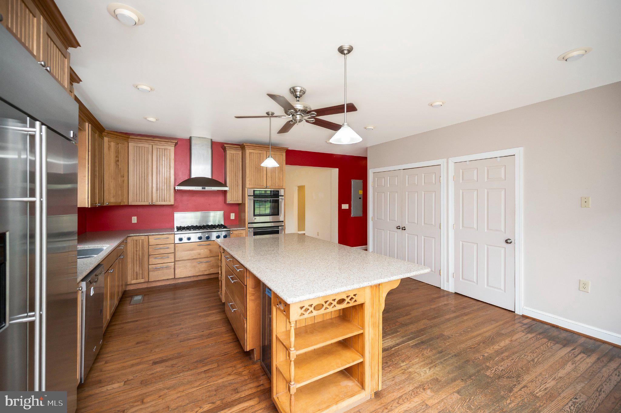 23202 Village Road Unionville, VA 22567 - Photo 23 of 58 a kitchen with stainless steel appliances a stove cabinets and wooden floor