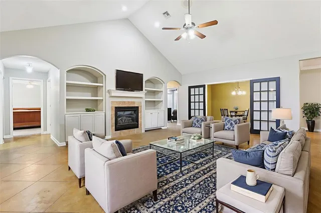 a living room with furniture and a chandelier