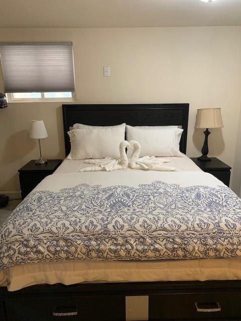 73 Bartlett Place Brooklyn, NY 11229 - Photo 12 of 14 a large bed sitting in a bedroom next to a window