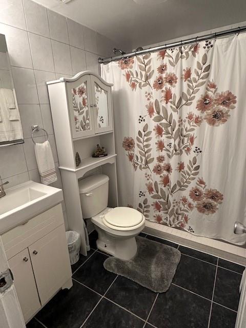 73 Bartlett Place Brooklyn, NY 11229 - Photo 13 of 14 a white toilet sitting next to a white sink and a shower curtain
