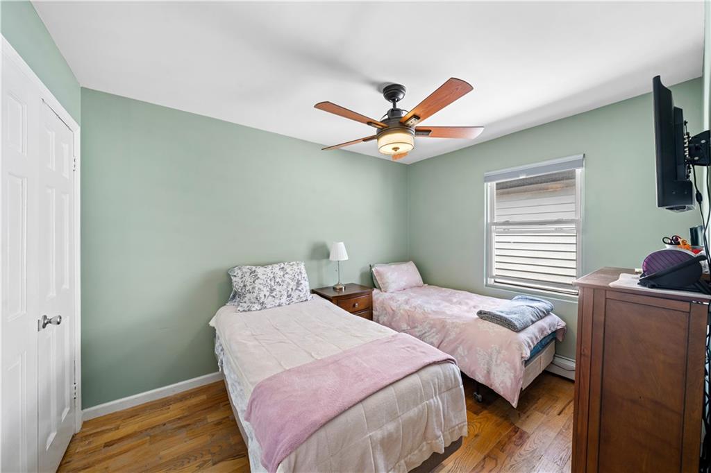 73 Bartlett Place Brooklyn, NY 11229 - Photo 8 of 14 a bedroom with two beds and a chandelier