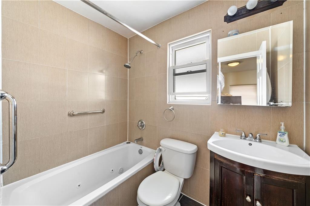 73 Bartlett Place Brooklyn, NY 11229 - Photo 9 of 14 a bathroom with a sink toilet and shower