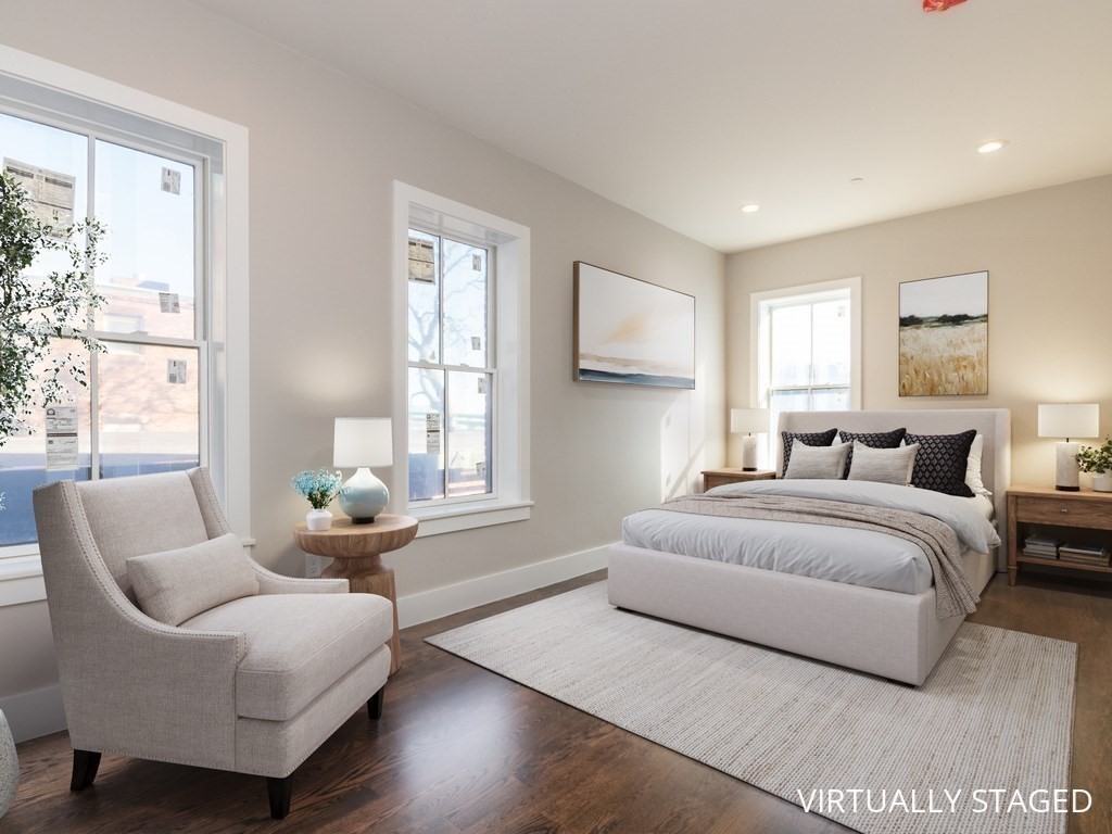 9 Monument Square, Unit 1 Boston, MA 02129 - Photo 4 of 15 a spacious bedroom with a bed and windows