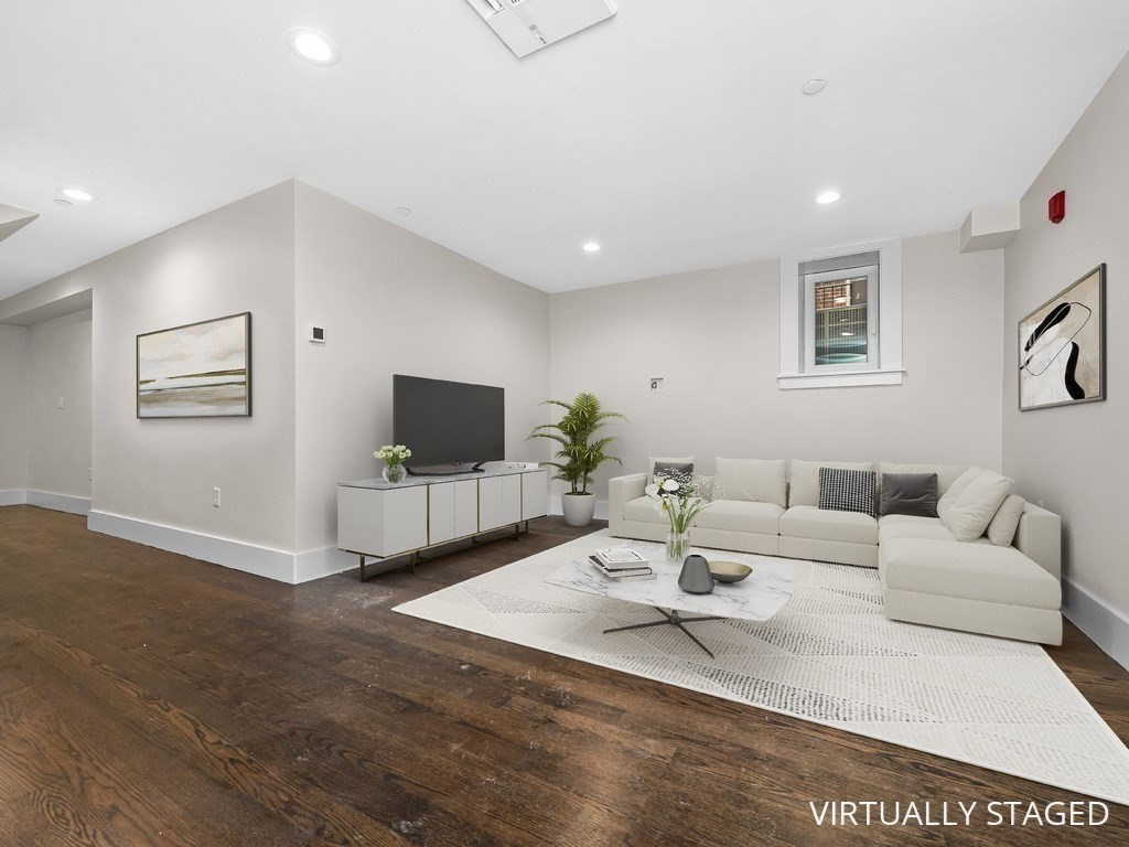9 Monument Square, Unit 1 Boston, MA 02129 - Photo 9 of 15 a living room with furniture and a flat screen tv