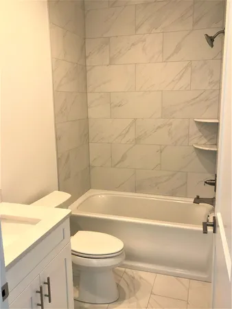 a bathroom with a toilet and a bath tub