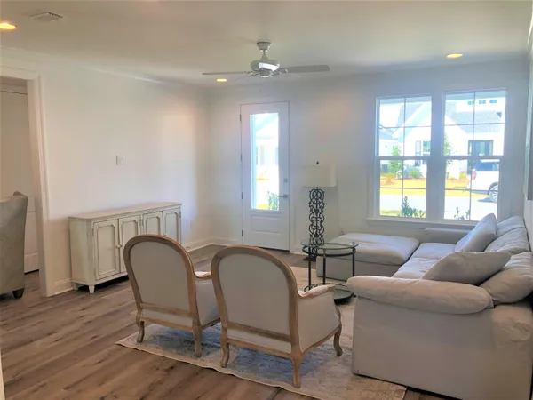 a living room with furniture and wooden floor
