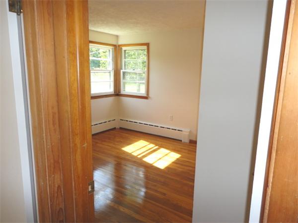 744 Wheelwright Road Barre, MA 01005 - Photo 6 of 10 a view of empty room with wooden floor and fan