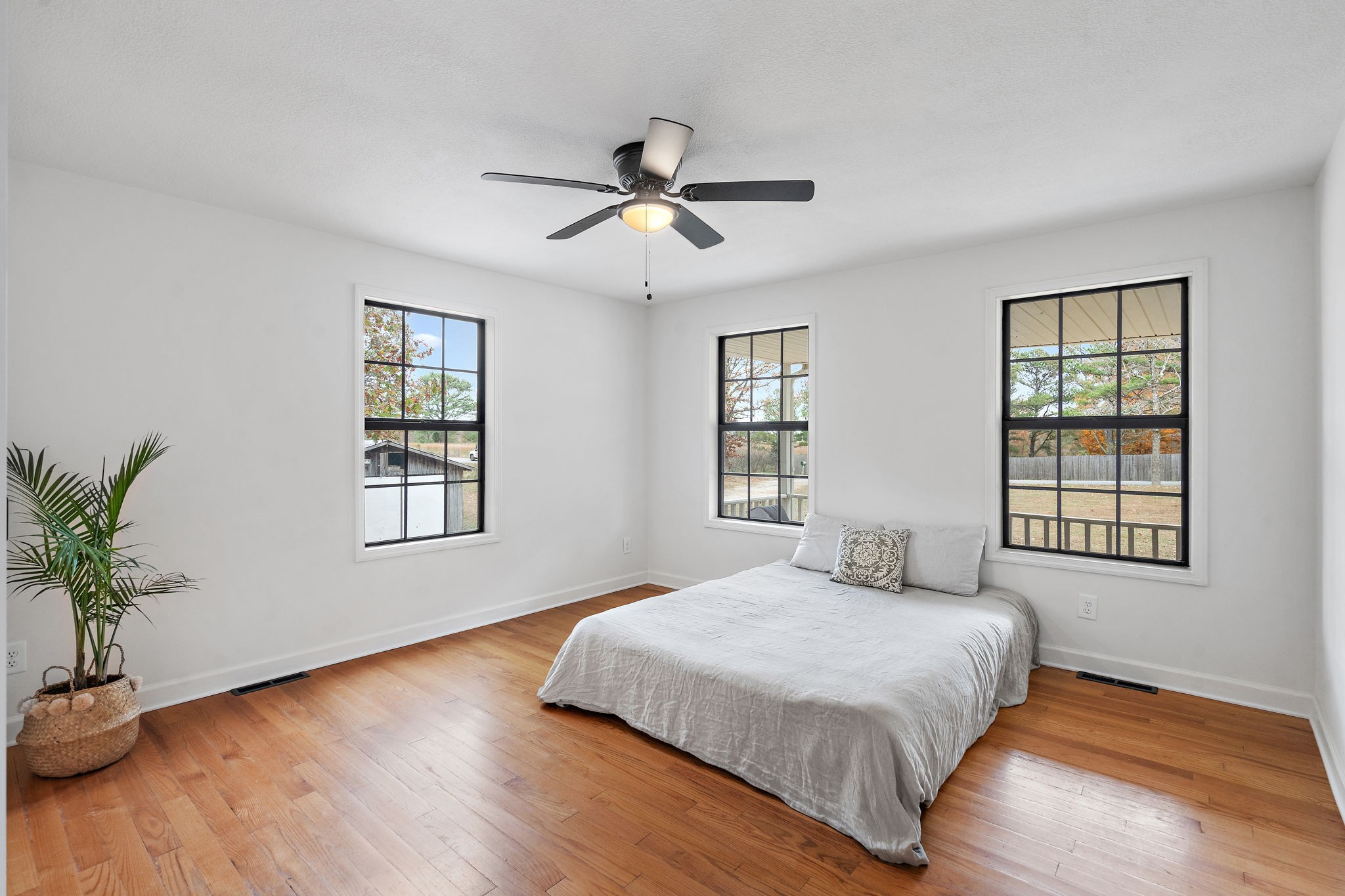 131 Locker Road Summertown, TN 38483 - Photo 16 of 38 a bedroom with a large bed chandelier and windows