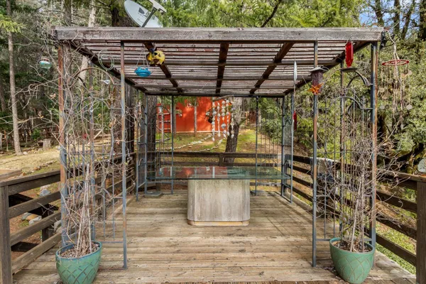 a backyard of a house with barbeque oven table and chairs