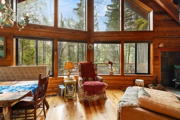 a view of patio with table and chairs and wooden floor