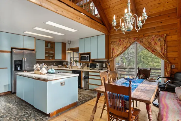 a kitchen with stainless steel appliances granite countertop a stove refrigerator sink and dishwasher