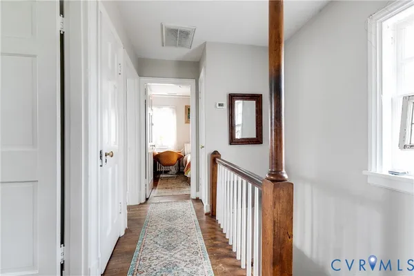 a view of a hallway with a livingroom and a window