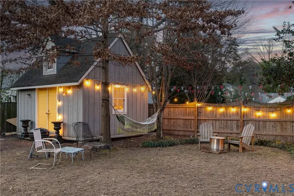 a backyard of a house with table and chairs