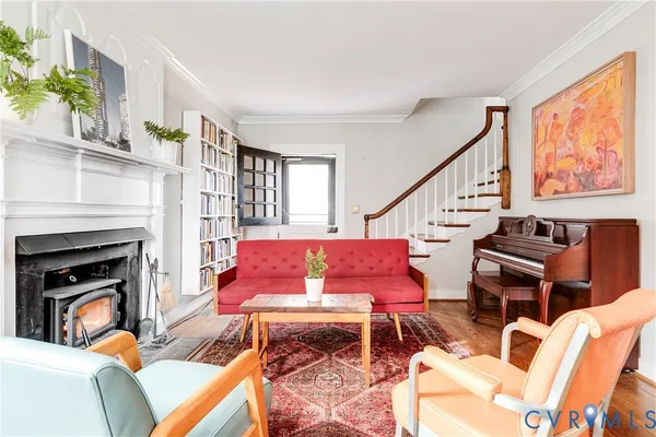 a living room with furniture a red rug and a fireplace