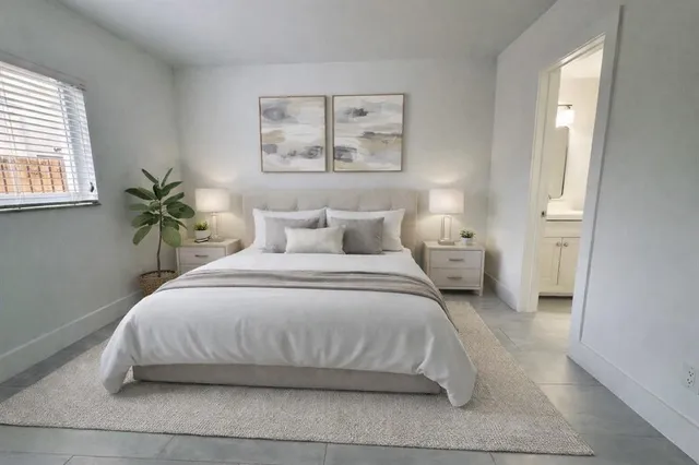 a bedroom with a bed and window