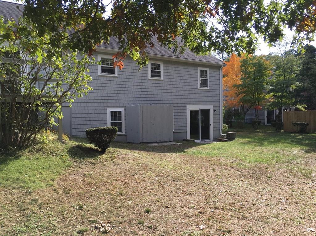 69 Stub Toe Road Barnstable, MA 02635 - Photo 7 of 27 a backyard of a house with a large tree