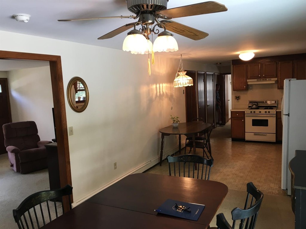 69 Stub Toe Road Barnstable, MA 02635 - Photo 8 of 27 a view of a dining room with furniture a chandelier and wooden floor