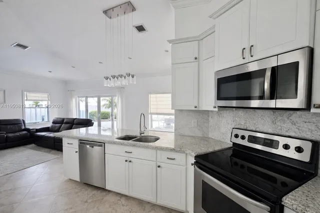 a kitchen with a sink stove and microwave