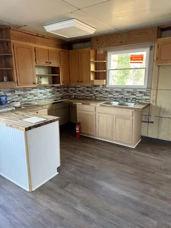 a kitchen with stainless steel appliances granite countertop wooden cabinets and a granite counter tops