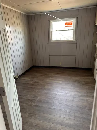 a view of a room with wooden floor and windows