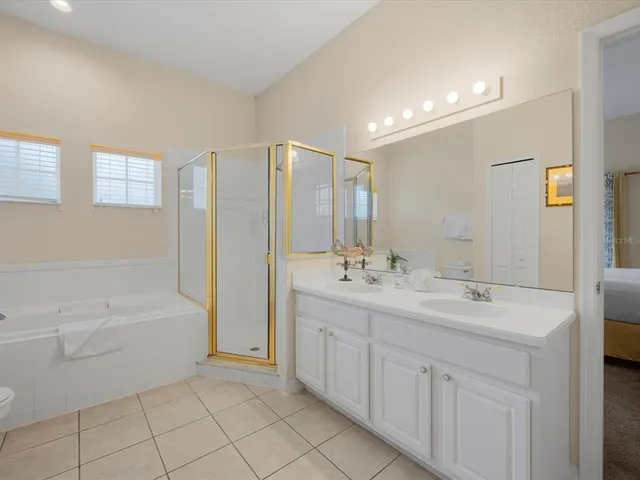 a bedroom with a bed and a lamp