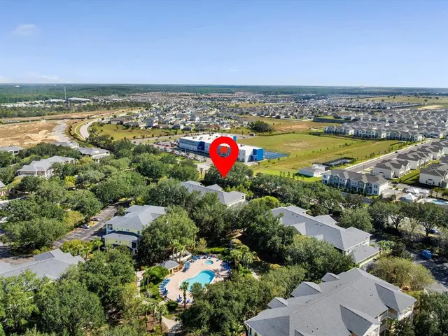 an aerial view of a houses with a swimming pool