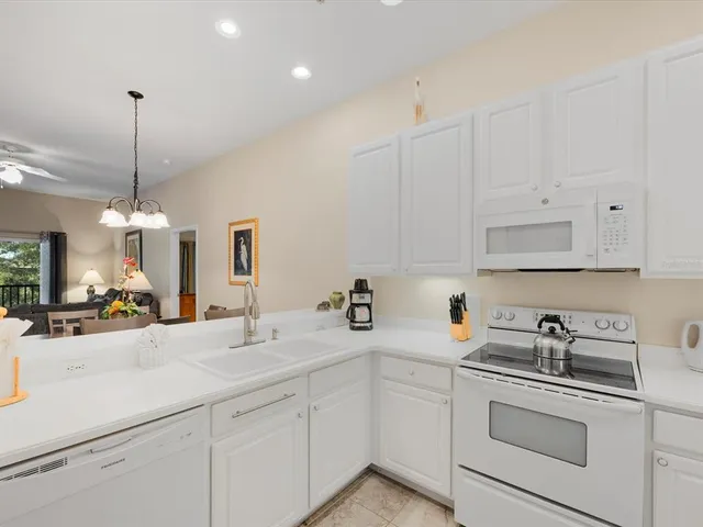a kitchen with stainless steel appliances a sink a stove and cabinets