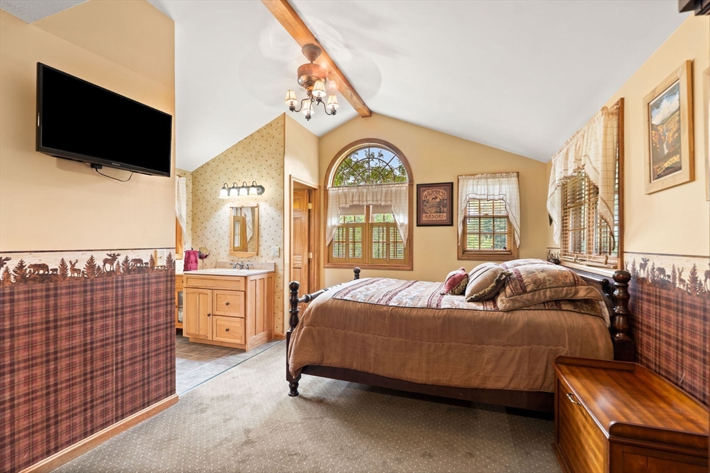 4 Alpha Road Groveland, MA 01834 - Photo 23 of 41 a bedroom with a bed and a flat tv screen on dresser