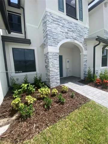 a front view of a house with a garden