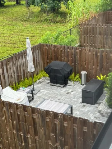 a view of a backyard with chair and table
