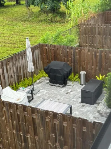 a view of a backyard with chair and table