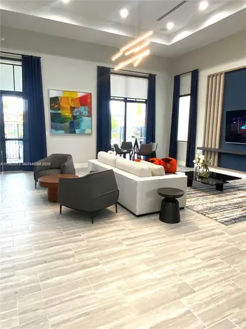 a living room with furniture window and a flat screen tv