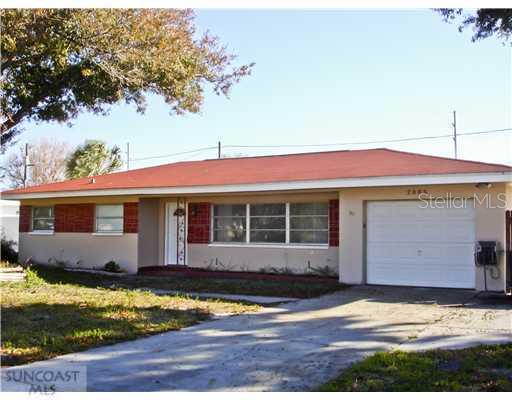 2005 7th Place Southwest Largo, FL 33770 - Photo 1 of 1 a front view of a house with a yard and garage