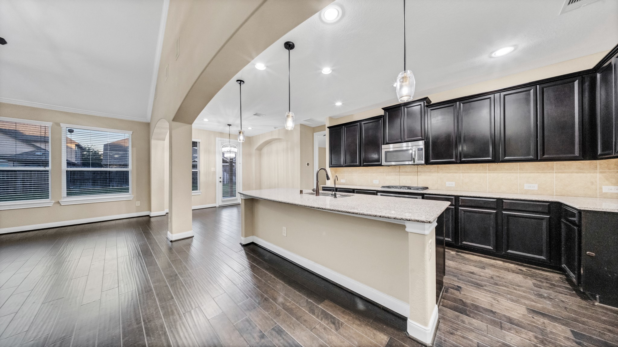 18118 Berry Garden Lane Spring, TX 77379 - Photo 15 of 45 Extended granite island with pendant lighting and generous prep space, open to the breakfast area and living room.